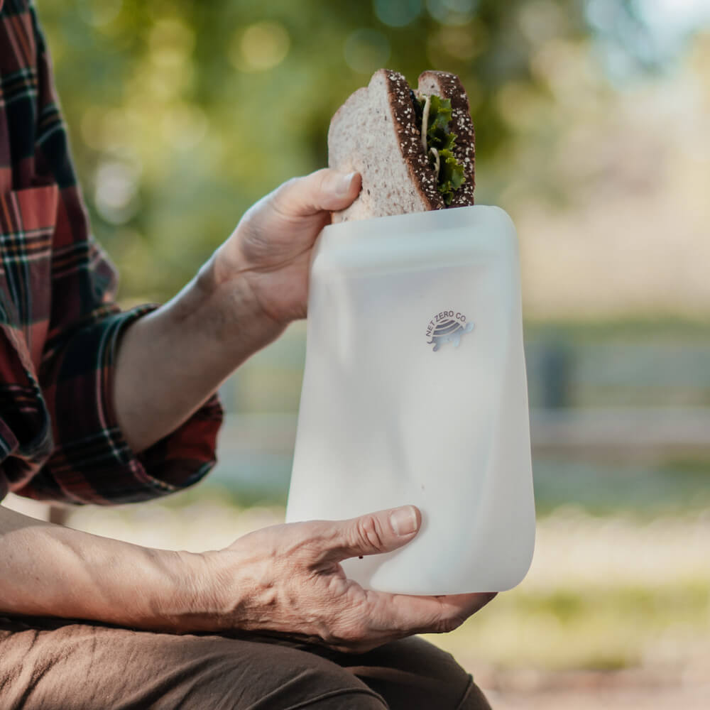 Hand pulling out sandwich from large Silicone Zip Sealer.